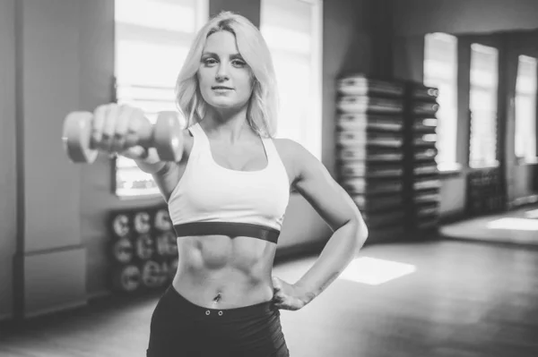 Strong sexy athletic young woman working out in gym — Stock Photo, Image