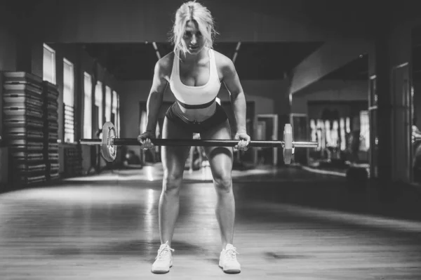 strong sexy athletic young woman working out in gym