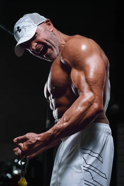 ผู้ชายนักกีฬาที่แข็งแกร่งหล่อ ปั๊มขึ้นกล้ามเนื้อ biceps ออกกําลังกาย f — ภาพถ่ายสต็อก