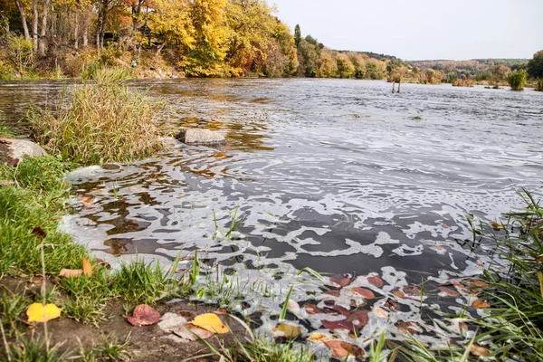 polluted river with foam on the surface