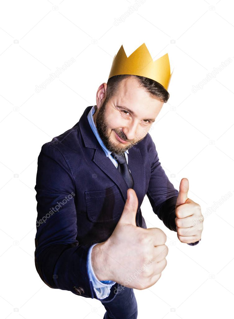 The concept of success. Portrait of a bearded man with a golden crown on his head on isolated white background.