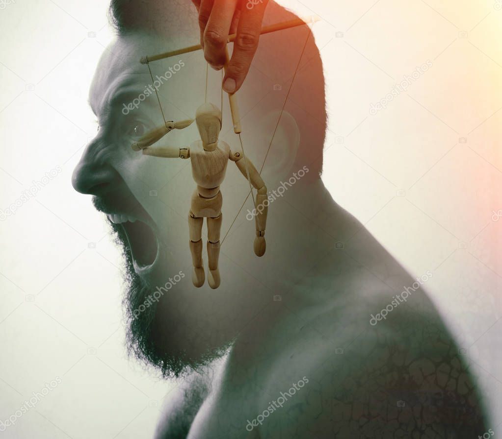 Man with marionette in his head. Concept of mind manipulation and hypnosis. Image created using double exposures.