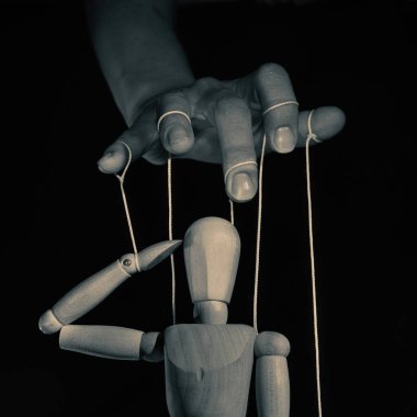 Concept of control. Marionette in human hand l, black and white. Image. clipart