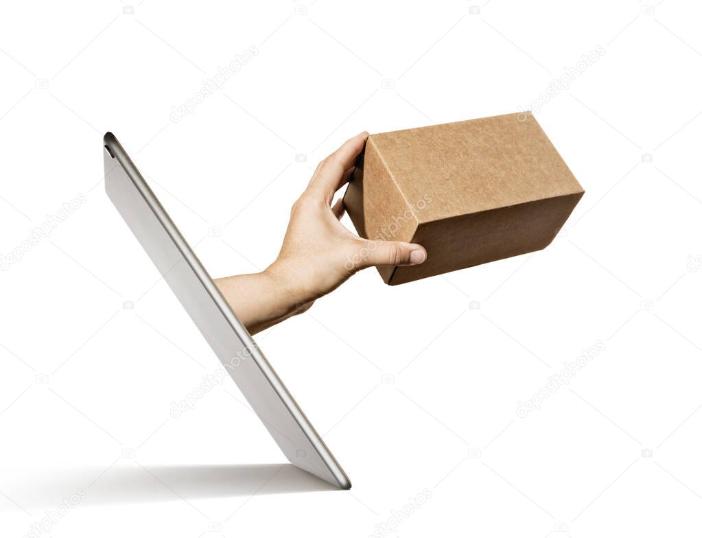 Hand with carton box stick out of a digital tablet screen. Concept of purchases in online store, delivery.