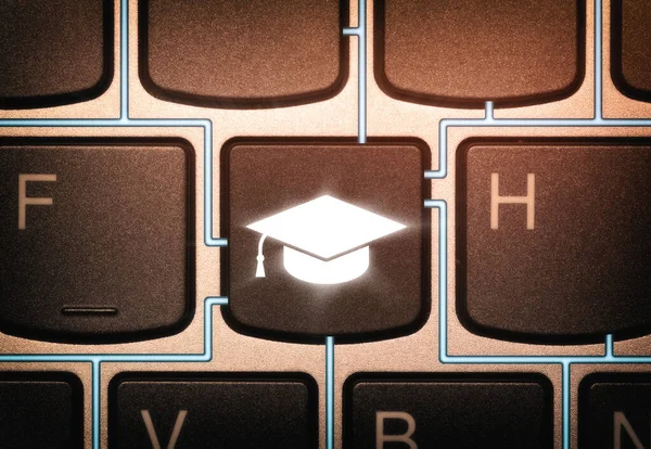 Key on a keyboard with graduation hat icon. Concept of online education.
