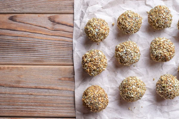 Top view of Low-fat energy balls with nuts on paper. Left copy space