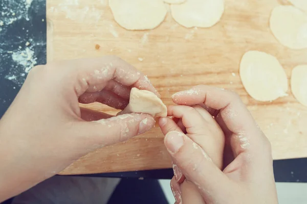 hands mom and baby mold food dough