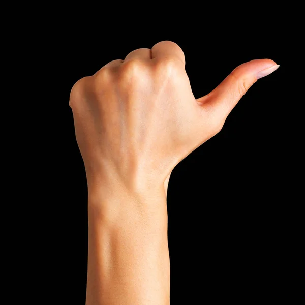 Woman holding hand in gesture of like sign, giving thumb up