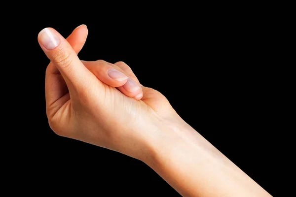 Жінка рука тримає щось з двома пальцями — стокове фото