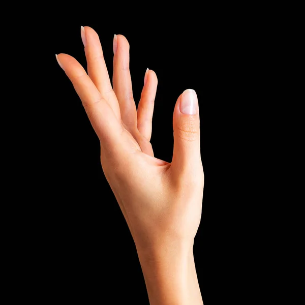 Ženská ruka drží něco dvěma prsty — Stock fotografie