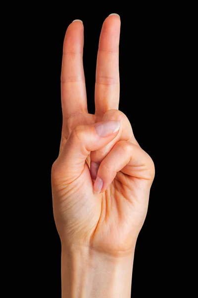 女性的手在和平象征中显示出两根手指 — 图库照片
