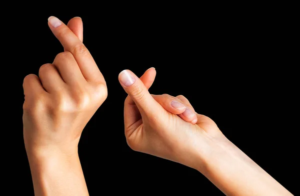 Frauenhand, die etwas mit zwei Fingern hält — Stockfoto