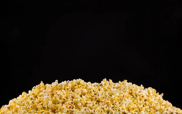 Scattered popcorn isolated on a black background