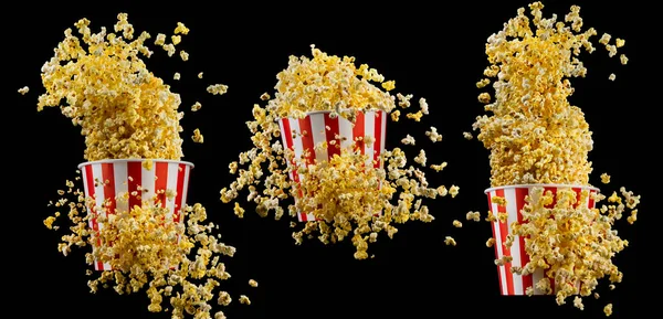 Set of paper striped buckets with popcorn isolated on black background — Stock Photo, Image