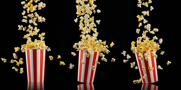 Set aus Papiereimern mit Popcorn isoliert auf schwarzem Hintergrund — Stockfoto