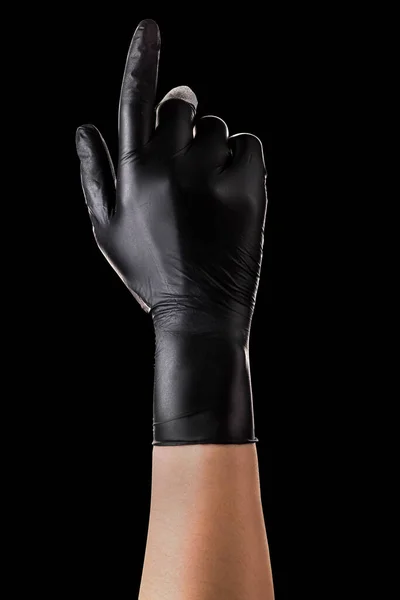 Hand in black gloves with the index finger pointing up on black — Stock Photo, Image