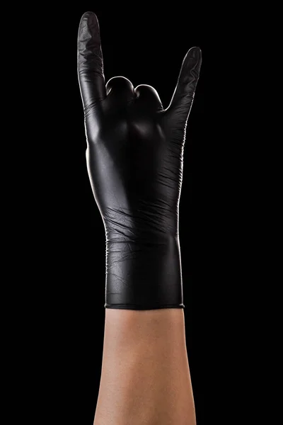 Hand in zwarte handschoenen met rock n roll teken of het geven van de duivel hoorns gebaar — Stockfoto
