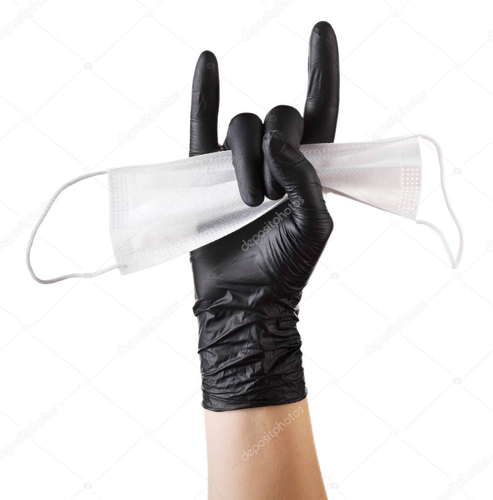 Hand in black gloves holding disposable face mask isolated on white background