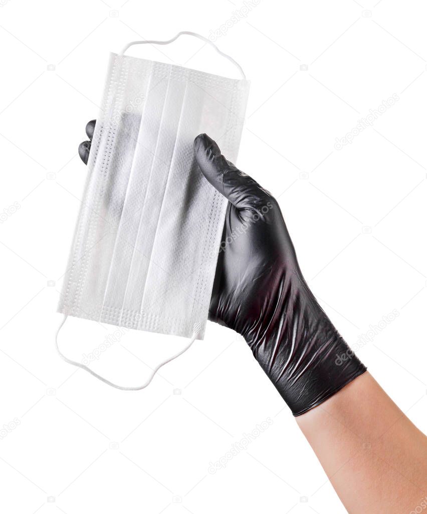 Hand in black gloves hold disposable face mask isolated on white background with clipping path. Concept of medical and healthcare