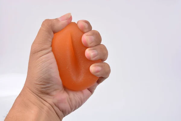 Hands of a man squeezing a stress ball, Hand Strength Therapy Squeeze Grip Ball — Stock Photo, Image