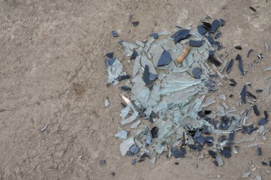 Yerde kırık cam parçaları var.