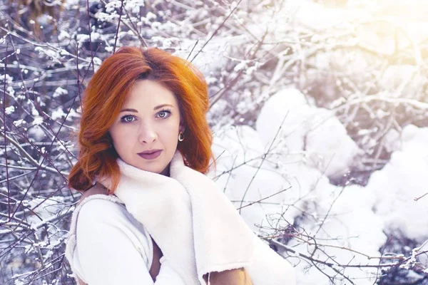 Woman walking in winter in the forest.