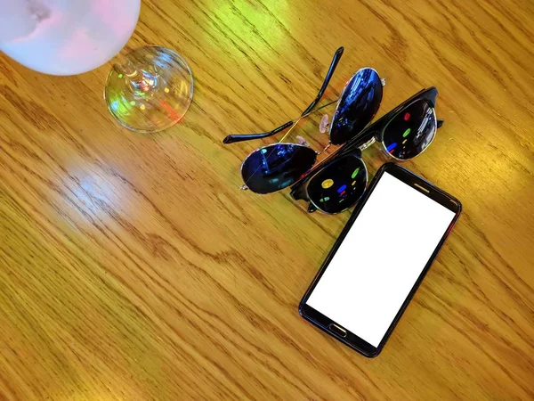 Phone and a couple glasses.