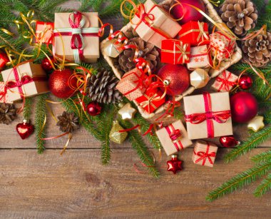 Noel ve yeni yıl arka plan: cam oyuncaklar, süslemeleri ve hediyeler ahşap arka plan üzerinde renkli