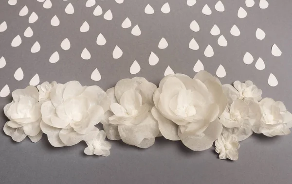 White flowers under rain. Card. Everything is made of paper. A place for congratulations.