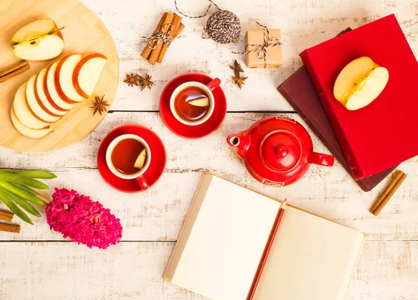 gift, notepad, apple, tea, flower  on wooden table