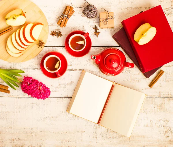 gift, notepad, apple, tea cups, flower  on wooden table