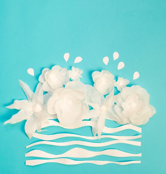 White flowers on a blue  background. Card. Everything is made of paper. A place for congratulations.