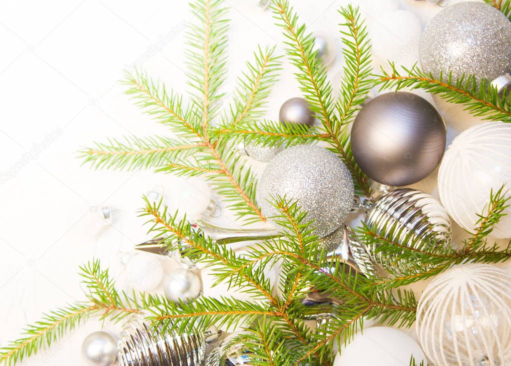 Christmas or New Year background: fir tree branches, glass balls, decorations. Place for your congratulations.