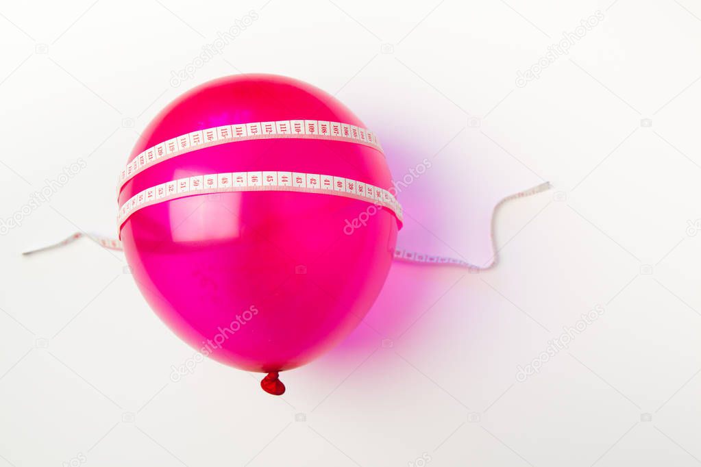 Idea of weight loss. Balloon with measuring tape 