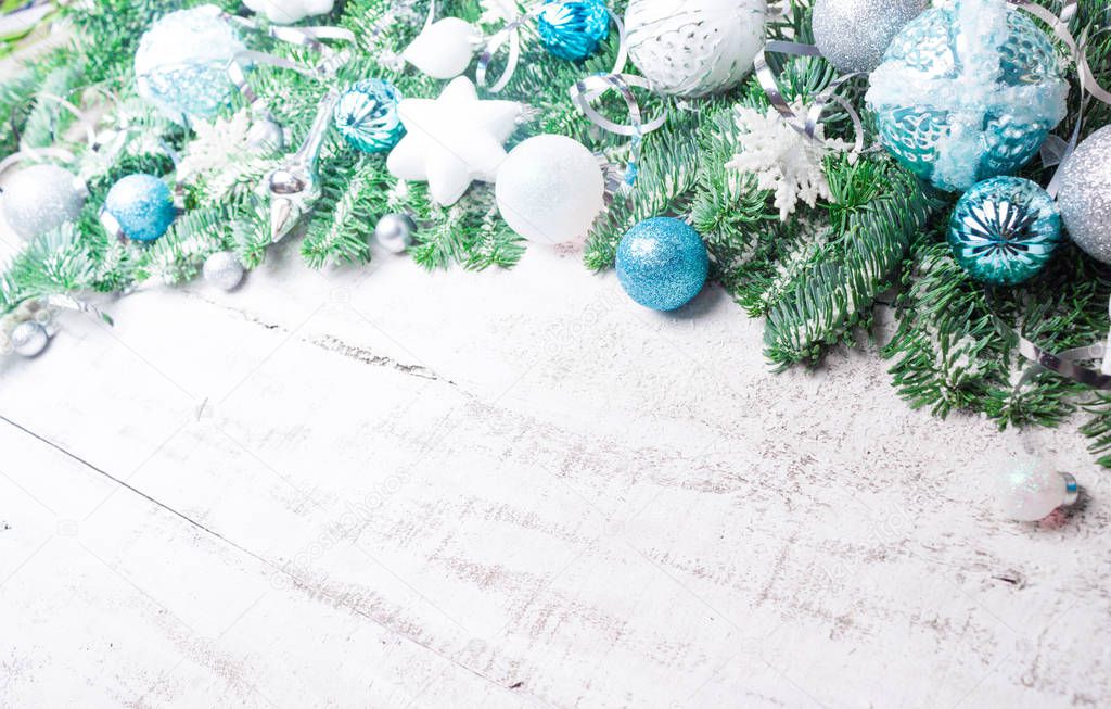 Christmas or New Year background: fir tree branches,  balls, decorations. Place for your congratulations.