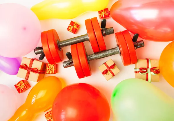 Composition with dumbbells, gift, balloon for healthy lifestyle and sport