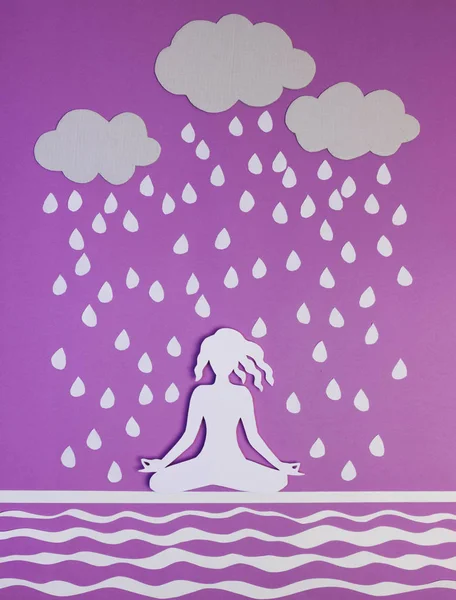 Yoga. Figure of  woman practicing yoga in rainy weather. Everything is made of paper.