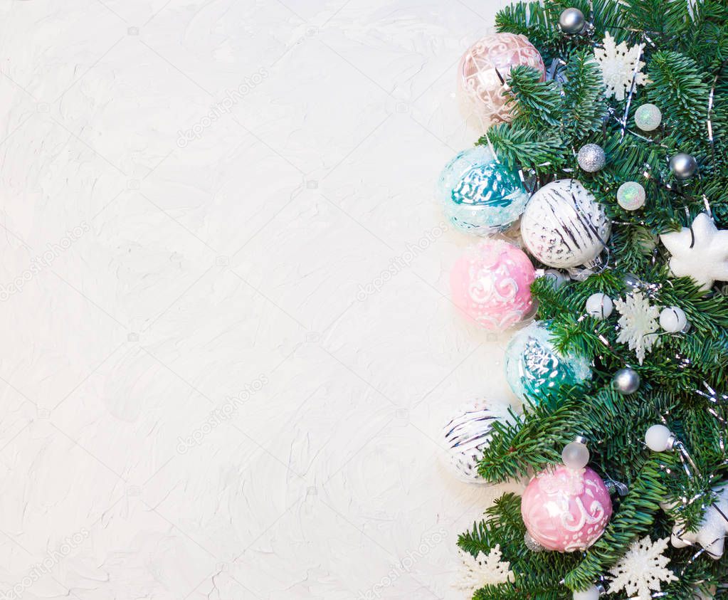 Christmas or New Year background: fir tree branches, glass balls, decorations. Place for your congratulations.