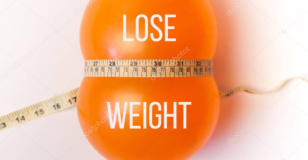 Idea of weight loss. Balloon with measuring tape. Lose weight text 