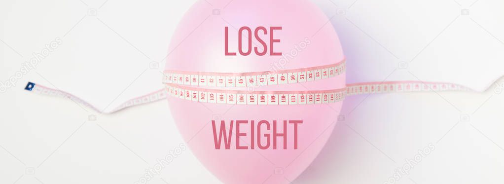 Idea of weight loss. Balloon with measuring tape 