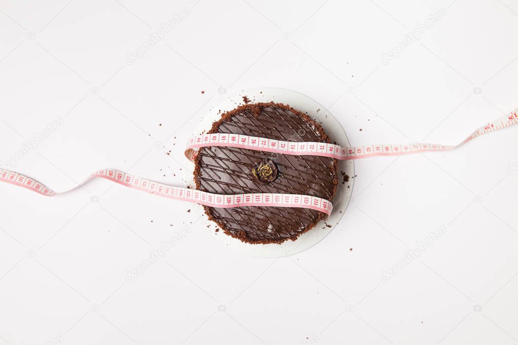 Brown cake with measuring tape 
