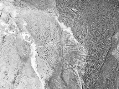 Close up of freshly poured cement and sand mixture showing raw texture and natural abstract pattern. Isolated detail with rough mood. Suitable for construction, industry, and background concepts.