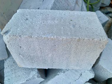 Close-up of lightweight concrete block (hebel) with rough texture stacked in construction site. Clear detail and sharp focus. Perfect for building, architecture, and industry concept.