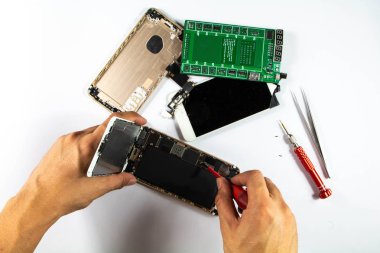 Mobil onarım teknisyenleri değiştirme için pili çıkarmaya hazırlanıyor.