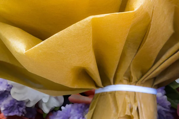 Make a bouquet of yellow paper.