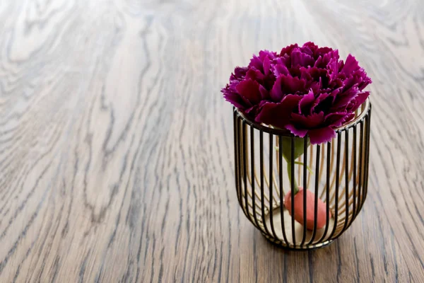 Artificial wood flowerpot on wooden table, small light brown colour in room with copy space.
