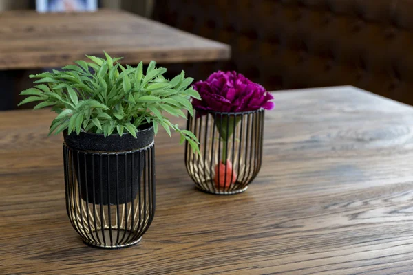 Artificial wood flowerpot on wooden table, small light brown colour in room with copy space.