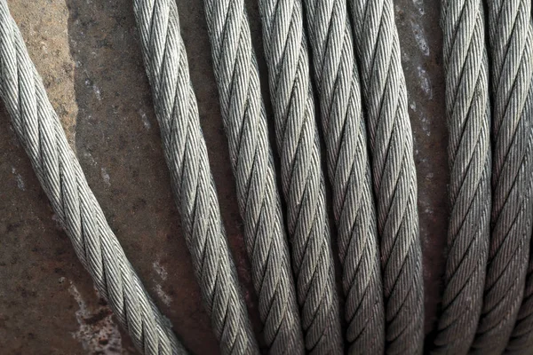 Closeup on old and rusty steel cable of crane the lifting machine in heavy industrial