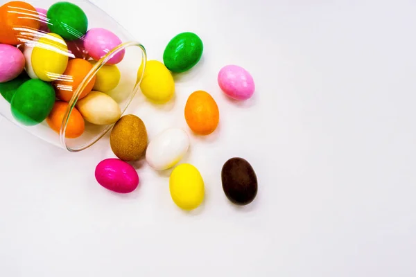 Colorful colored candy scattered from clear glass cups View background White background with text area