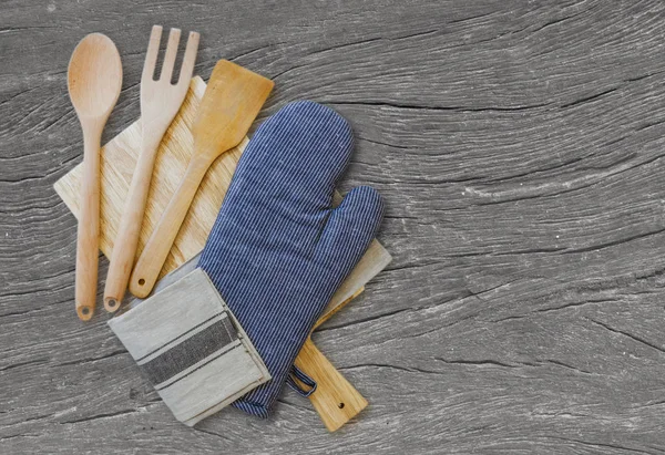 Wooden spoons and other cooking tools with blue napkins on the kitchen table. selective focus, blurred space for text